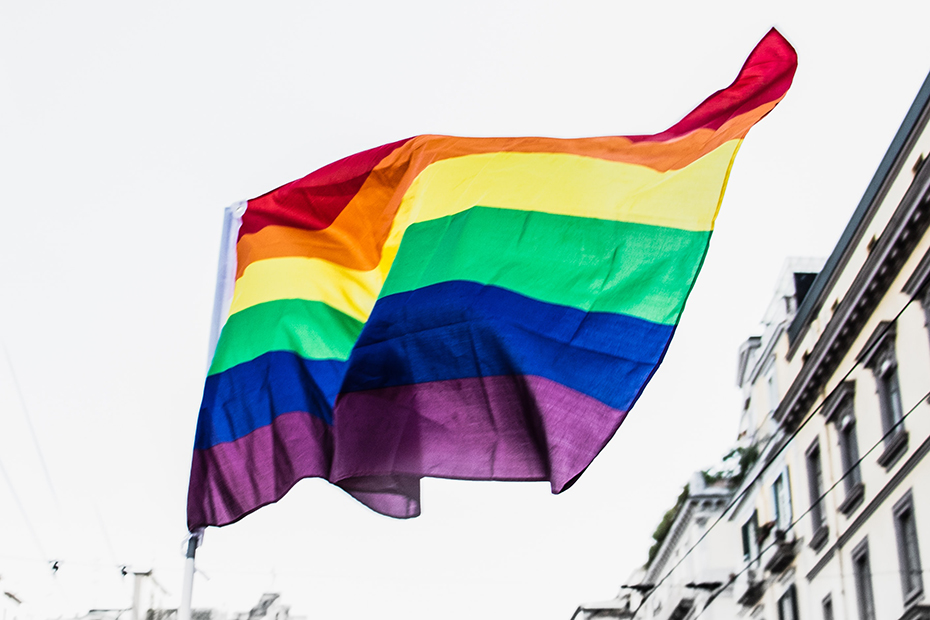 Pride Flag waving on city street